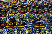 Bangkok Wat Pho, the group of the chedi of the four kings, detail of multicolored mosaic flowers made from Chinese ceramic bowls cut into petal shapes. 